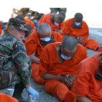 Detainees on arrival to Camp X-Ray, the holding facility at Guantánamo Bay, Cuba. © US DoD
