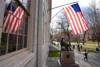 People walk past the John Harvard statue in Harvard Yard, Tuesday, Dec. 17, 2024, on the campus of Harvard University in Cambridge, Mass. (AP Photo/Steven Senne