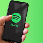 Spotify logo Smartphone displaying the Spotify logo. Spotify is an audio streaming service that offers users access to multiple forms of streaming media, including music, podcasts, and audiobooks