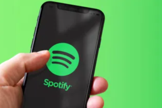 Spotify logo Smartphone displaying the Spotify logo. Spotify is an audio streaming service that offers users access to multiple forms of streaming media, including music, podcasts, and audiobooks