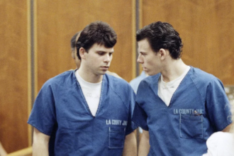 Lyle, left, and Erik Menendez leave the courtroom in Santa Monica, Calif., in August 1990. They were sentenced to life in prison without the possibility of parole in 1996 — and resentenced this week. Nick Ut/AP