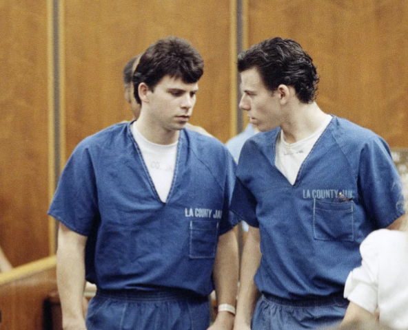 Lyle, left, and Erik Menendez leave the courtroom in Santa Monica, Calif., in August 1990. They were sentenced to life in prison without the possibility of parole in 1996 — and resentenced this week. Nick Ut/AP